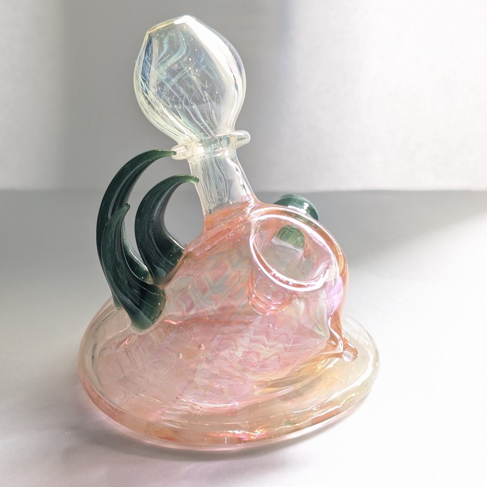 Pink and clear art-glass piece with dark green curled accents